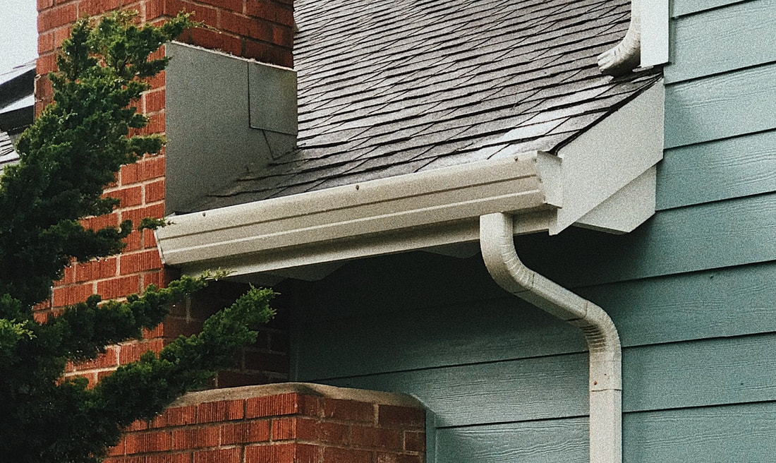 New rain gutter with downspout