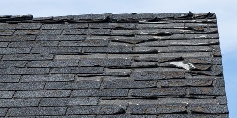Roof with badly damaged shingles