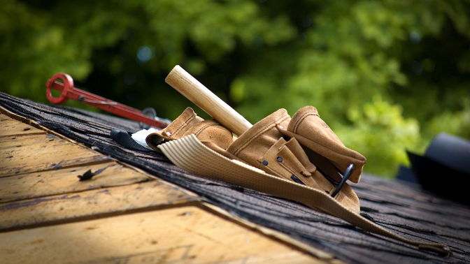Roofing tools and supplies on top of roofing project